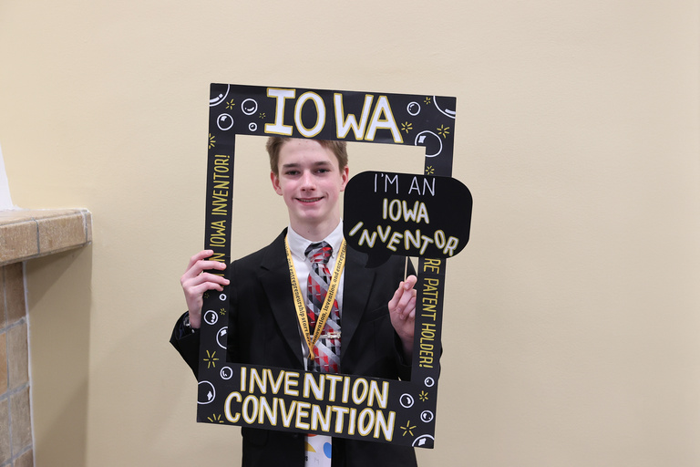 Student inventor taking picture at photo booth