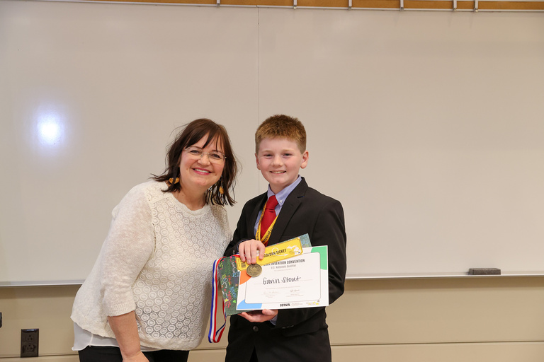 Student inventor receiving award.