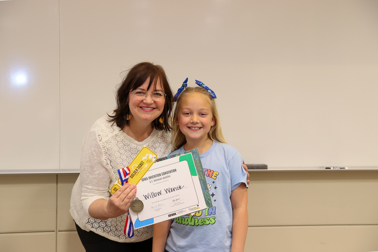 Student inventor receiving award.