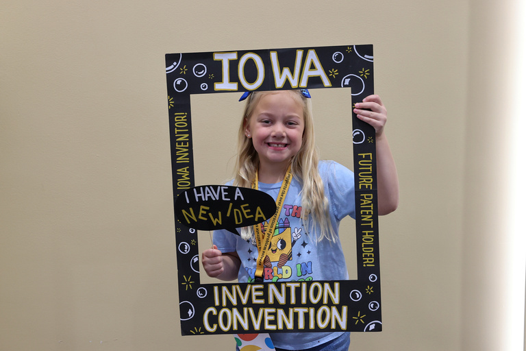 Student inventor taking picture at photo booth