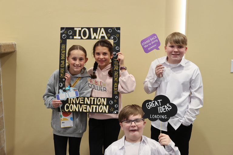 Student inventors taking picture at photo booth