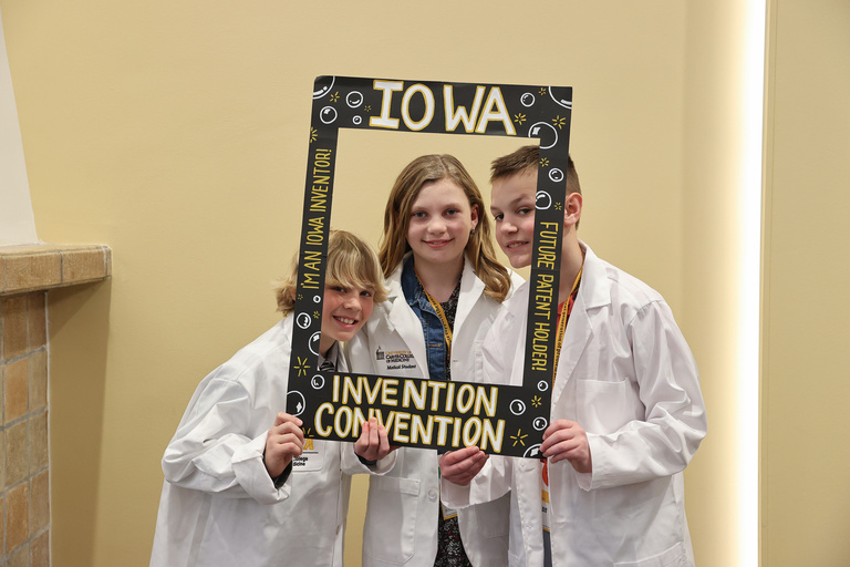 Student inventors taking picture at photo booth