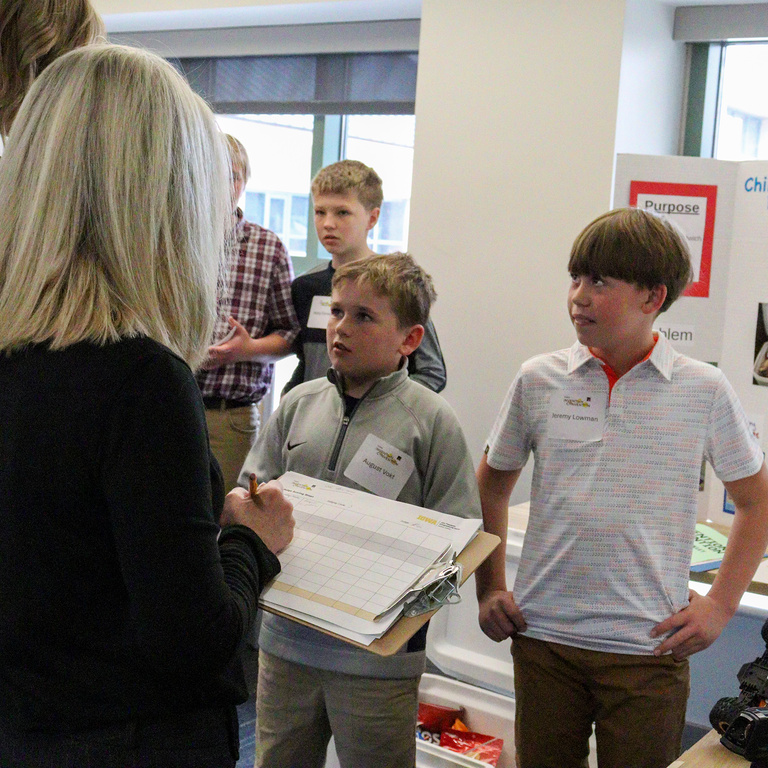 Two boy inventors presenting at the Iowa Invention Convention