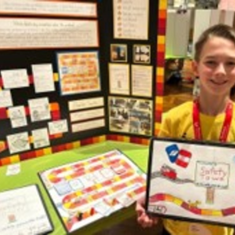 Charles at Invention Convention U.S. Nationals holding up his project
