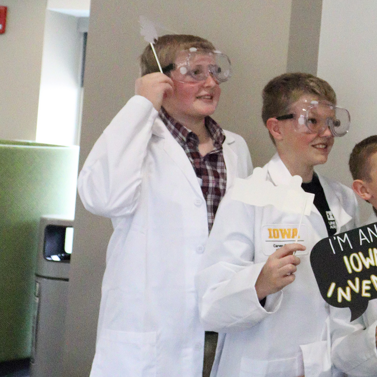 Three boys at the 2025 Iowa Invention Convention photo booth