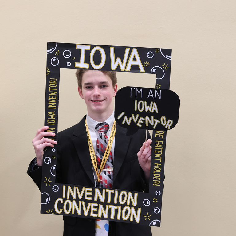 Student inventor taking picture at photo booth