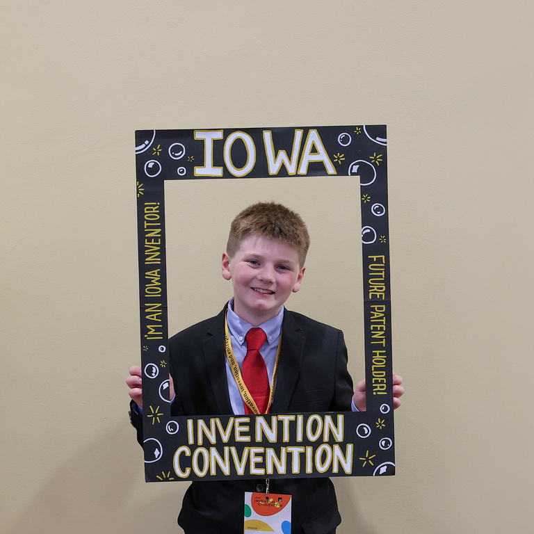 Student inventor taking picture at photo booth
