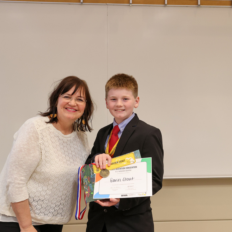 Student inventor receiving award.