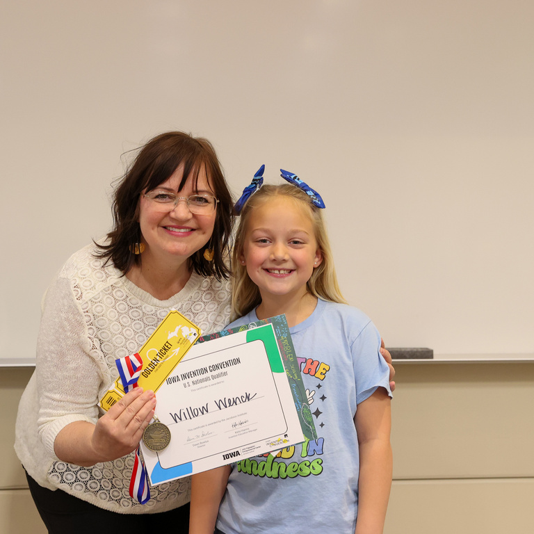 Student inventor receiving award.