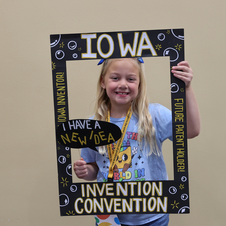Student inventor taking picture at photo booth