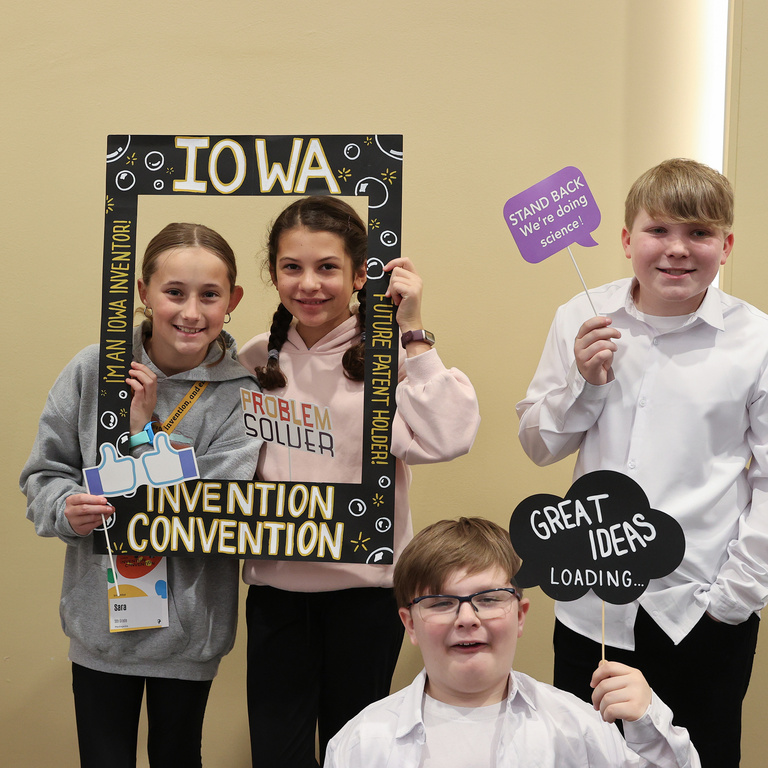 Student inventors taking picture at photo booth