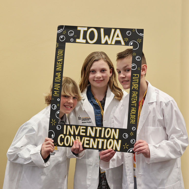 Student inventors taking picture at photo booth